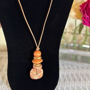 Coral, peach and‎ gold toned mixed pendant with leather adjustable cord.